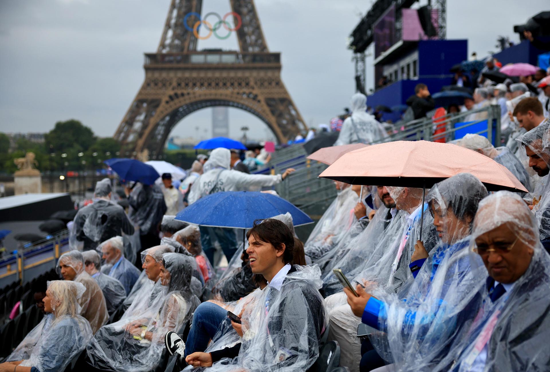 El público comienza a ocupar bajo la lluvia las gradas del Trocadero